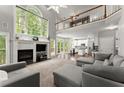 Spacious living room with tall windows, a fireplace, and an open layout at 2342 Tall Timbers Ln, Marietta, GA 30066