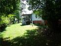 Shaded backyard with a deck and yard debris at 2900 Hitt Rd, Cumming, GA 30041