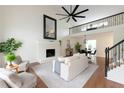 Bright living room featuring a fireplace, vaulted ceilings, and hardwood floors at 303 Roswell Green Ln, Roswell, GA 30075