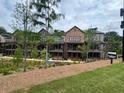 View of townhome-style homes with charming balconies and beautiful landscaping at 435 Chiswick Cir # 21, Alpharetta, GA 30009
