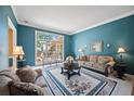 Cozy living room with a large window, plush sofas, and decorative accents at 569 Fairway Dr, Woodstock, GA 30189