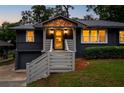 Exterior of a home showcasing dark gray brick, wood trim, an integrated garage, and steps to the door at 1494 May Se Ave, Atlanta, GA 30316