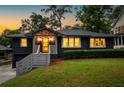 Charming exterior with brick, manicured bushes, and light gray stairs leading to the front door at 1494 May Se Ave, Atlanta, GA 30316