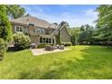 Expansive backyard with a well-manicured lawn and a patio area perfect for outdoor entertaining at 157 Lake Forrest Ne Ln, Atlanta, GA 30342