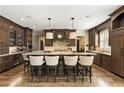 Gourmet kitchen with custom dark wood cabinetry, a large island with seating, and stainless steel appliances at 157 Lake Forrest Ne Ln, Atlanta, GA 30342