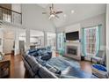Bright living room with vaulted ceilings, fireplace, hardwood floors, and large leather couch at 2995 Barimore, Dacula, GA 30019