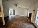 Open-concept living room with a fireplace, vaulted ceiling, and laminate flooring at 1120 Northern Run, Stockbridge, GA 30281