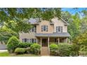 Inviting two-story home with covered porch, stairs and well-maintained landscaping at 1637 Willow Way, Woodstock, GA 30188