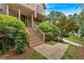 Covered front porch with stairs and decorative landscaping create a warm welcome at 1637 Willow Way, Woodstock, GA 30188