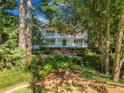 Charming two-story home featuring a welcoming facade with double balconies and a well-manicured front yard at 2390 Sassafrass Ln, Powder Springs, GA 30127