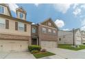 Charming townhouse showcasing brick and siding exterior, attached garages, and well-maintained landscaping at 3255 Clear View Dr, Snellville, GA 30078
