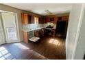 An eat-in kitchen with wood cabinets, dated appliances and a sunlit window, ready for updates at 43 Oak Landing Cir, Douglasville, GA 30134