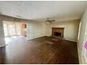 Spacious living room featuring a stone fireplace, ceiling fan and access to adjacent dining area at 43 Oak Landing Cir, Douglasville, GA 30134
