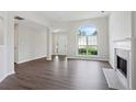 Living room with a fireplace, large arch window, and ample natural light at 3025 Andora Sw Dr, Marietta, GA 30064