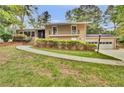 Well-maintained home featuring manicured landscaping, a covered porch, and an attached two-car garage at 4794 Glenbonnie Ct, Atlanta, GA 30360