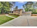 Beautiful two-story home with a large driveway, mature trees, and attached garage at 4794 Glenbonnie Ct, Atlanta, GA 30360