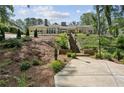 Beautiful ranch-style home with lush landscaping, stone stairs and hardscaped driveway providing elegant curb appeal at 511 Pine Valley Se Rd, Marietta, GA 30067