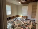 Bright bedroom with unique tile flooring, ceiling fan and natural light from dual windows, offering a cozy retreat at 915 Lake Dr, Snellville, GA 30039