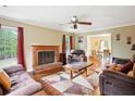 Cozy living room with a brick fireplace, wood floors, and comfortable seating, perfect for relaxation at 285 Aspen Way, Fayetteville, GA 30214