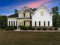 Charming two-story home with stone accents, a covered porch, lush landscaping, and a well-manicured lawn at 2855 Pilgrim Mill, Cumming, GA 30041