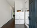Modern entryway featuring dark hardwood floors, white storage and decor at 3481 Lakeview Crk, Lithonia, GA 30038