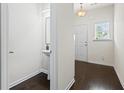 Hallway with dark hardwood floors, a sleek sink, and natural light from a window at 3481 Lakeview Crk, Lithonia, GA 30038