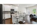 Contemporary kitchen boasts granite counters, stainless appliances, and island seating at 3481 Lakeview Crk, Lithonia, GA 30038