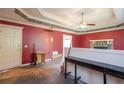 A spacious living room boasts a stone fireplace, ceiling fan, and neutral paint at 911 White Stag Ln, Canton, GA 30115