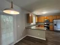 Well-lit kitchen featuring granite countertops, stainless steel appliances, and door to the backyard at 1415 Stoney Field Pl, Lawrenceville, GA 30043