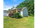 Exterior side view showing the home's design, landscaping, and well-maintained yard at 175 Orchard Ln, Covington, GA 30014