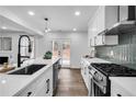 Modern kitchen with stainless steel appliances, a stylish backsplash, and a view of the backyard at 3290 Ethan Drive, Marietta, GA 30062