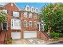 Beautiful brick townhome featuring a two-car garage and steps leading to the entrance at 451 Tioram Se Ln, Smyrna, GA 30082
