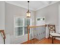 Upstairs hallway featuring wood floors, natural light and decorative wrought iron railing at 451 Tioram Se Ln, Smyrna, GA 30082