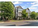 Stylish townhome featuring a second-story balcony, manicured landscaping, and an inviting facade at 518 Hargrove Ln, Decatur, GA 30030