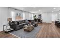 Spacious living room with hardwood floors, a large sectional sofa, and ample natural light at 1536 Daffodil Drive, Marietta, GA 30062