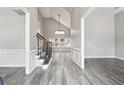 Inviting foyer boasting soaring ceilings, elegant staircase with iron spindles, and beautiful wood floors at 9811 Spyglass Dr, Villa Rica, GA 30180