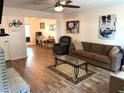 Bright and inviting living room featuring hardwood floors, a fireplace, and stylish decor at 210 Mill Creek Pl, Roswell, GA 30076