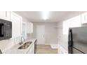 Modern kitchen with white cabinets, gray countertops, and stainless steel appliances at 568 Mcwilliams Se Rd, Atlanta, GA 30315