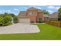 The exterior boasts an attached garage with a wide driveway at 1304 Swallows Walk, Grayson, GA 30017