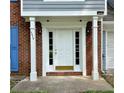 Inviting front door with white columns and sidelights, creating a warm entrance at 4970 Clubgreen Smt, Stone Mountain, GA 30088