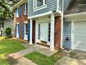 Inviting front porch with white columns, a bright white door, and well manicured lawn at 4970 Clubgreen Smt, Stone Mountain, GA 30088