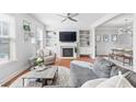 Cozy living room boasts a fireplace, built-in shelves, and lots of natural light at 3690 Lambert Ne Ln, Atlanta, GA 30319