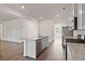 Bright kitchen featuring granite countertops, stainless steel appliances, and an island with a sink at 4117 Flat Rock Pt, Stonecrest, GA 30038