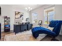 Bright home office with dark wood floors, large windows, and a chaise lounge at 639 Tigers Eye Ter, Kennesaw, GA 30144