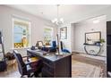 Bright home office with large desk, two windows, and a view of the backyard at 639 Tigers Eye Ter, Kennesaw, GA 30144