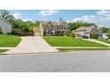 Beautiful two-story home with brick and siding exterior, attached two car garage, and manicured lawn at 422 Silver Brook Dr, Woodstock, GA 30188