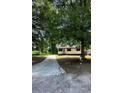 Single story home with a long driveway and mature trees at 50 Evelyn Rd, Covington, GA 30016