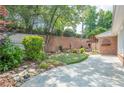 Backyard with a mini-golf setup, beautiful plants, stone wall, and privacy at 10280 Medridge Cir, Johns Creek, GA 30022