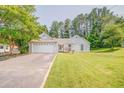 Charming single-story home featuring a well-maintained lawn and an attached two-car garage at 3288 Owens Meadow Ln, Kennesaw, GA 30152