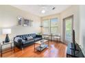 Cozy living room featuring hardwood floors, a black leather couch, and lots of natural light at 898 Oak Sw St # 3420, Atlanta, GA 30310